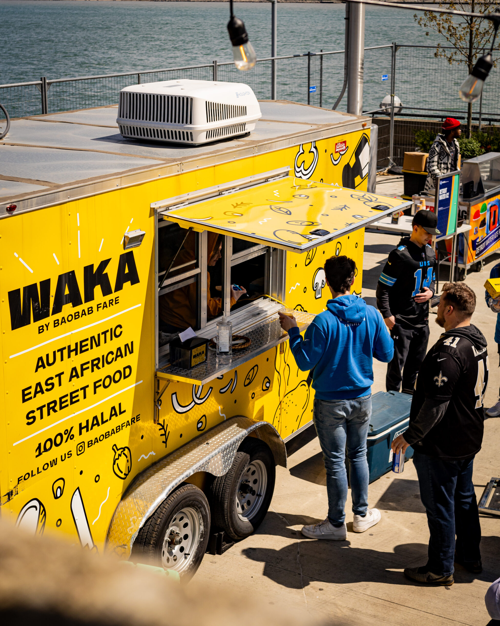 Patrons order East African street food from the Waka by Baobab Fare food truck in Detroit